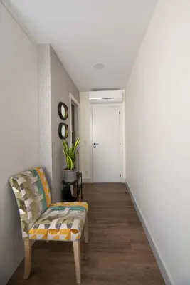 a living room with a chair and a staircase at LA CASITA DE FINA in Caldas de Reis