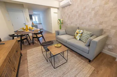 a living room with a couch and a table at LA CASITA DE FINA in Caldas de Reis