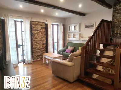 a living room with a couch and a stair case at Ibañez 3 in Ribadeo