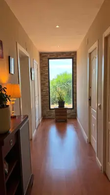 a hallway with a large window with a plant in it at CASAPUEBLO Arzúa in Campo
