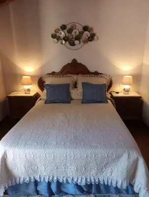 a bedroom with two beds and a painting on the wall at O Cobo Vacacional in Padrón
