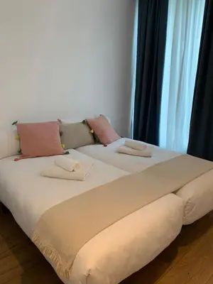two beds sitting next to each other in a room at OKTHEWAY PERBES HOUSE in A Coruña