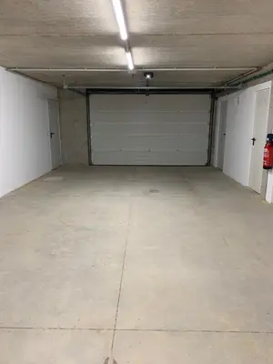 a garage with two garage doors and a concrete floor at OKTHEWAY PERBES HOUSE in A Coruña