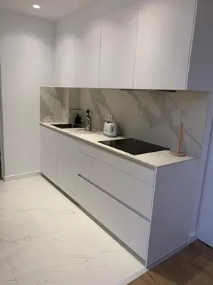 a white kitchen with white cabinets and a sink at OKTHEWAY PERBES HOUSE in A Coruña