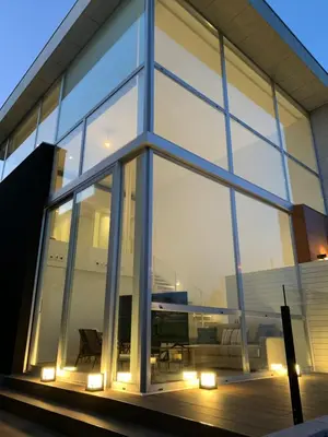 a building with large glass windows with a piano at OKTHEWAY PERBES HOUSE in A Coruña