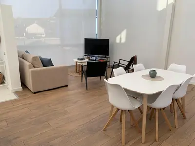 a living room with a white table and chairs at OKTHEWAY PERBES HOUSE in A Coruña