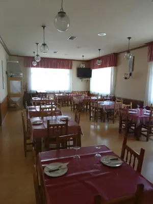 a dining room with wooden tables and chairs at Hostal Carpinteiras in Rodeiro