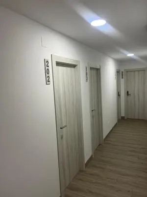 an empty hallway with doors in a building at Hostal Carpinteiras in Rodeiro
