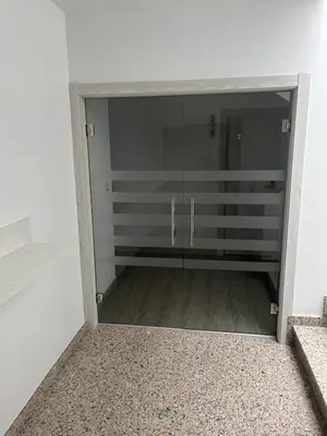 a closet with a glass door in a room at Hostal Carpinteiras in Rodeiro