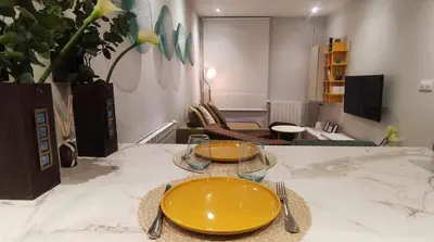 a table with two yellow plates on top of it at Estación de Montaña Manzaneda, Ciudad de Lugo, 114 in Ourense