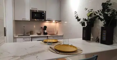 a kitchen with a table with two plates on it at Estación de Montaña Manzaneda, Ciudad de Lugo, 114 in Ourense