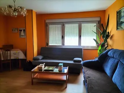 a living room with a couch and a coffee table at FOZ PLAYA RAPADOIRA in Foz