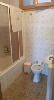 a small bathroom with a toilet and a sink at FOZ PLAYA RAPADOIRA in Foz