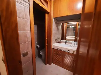 a bathroom with a sink and a toilet and a mirror at Casa rural en entorno privilegiado in Valongo