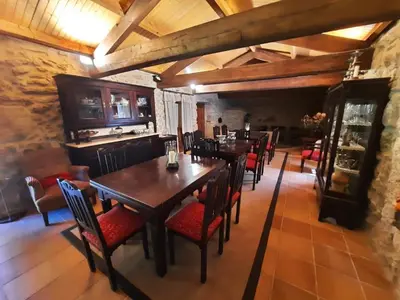 a dining room with wooden tables and red chairs at Casa rural en entorno privilegiado in Valongo
