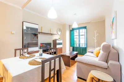 a living room with a table and a couch at ***** Solaina das Burgas ***** en el Casco Viejo in Ourense