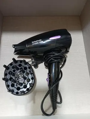 a black hair dryer sitting on top of a table at ***** Solaina das Burgas ***** en el Casco Viejo in Ourense