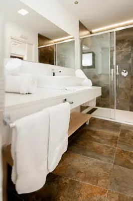 a white bathroom with two sinks and a shower at Casa Miño in Ourense