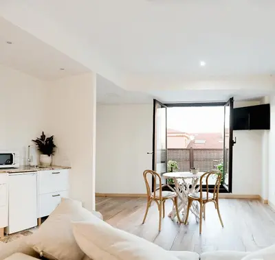 a kitchen and dining room with a table and chairs at Casa Miño in Ourense