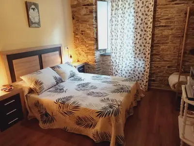 a bedroom with a bed and a window at A Casa das Augas in Mondoñedo
