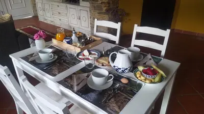a white table with a tea set on it at A Casa das Augas in Mondoñedo