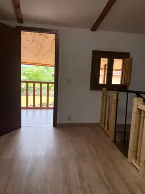 an empty room with wooden floors and a large window at Casa Anduriña in Ourense