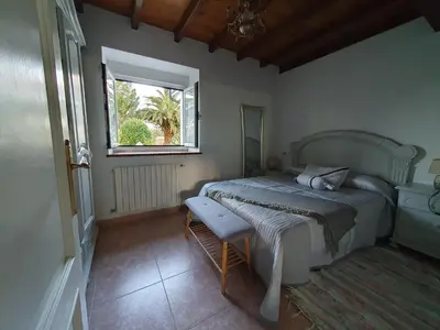 a bedroom with a bed and a window at Casa Arquella in Cartavio