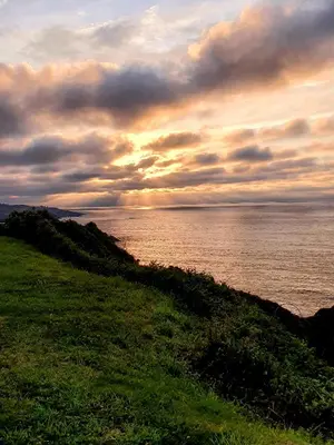 a view of the ocean from a grassy hill at Casa Arquella in Cartavio