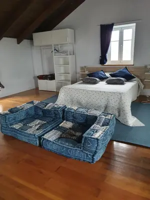 a bedroom with a bed and a couch in it at Casa Arquella in Cartavio