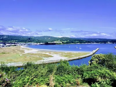 a view of a river with boats in the water at The Cliffs - Sunset Village Beach 3E in Viveiro