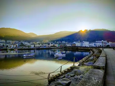 a city with boats in a body of water at The Cliffs - Sunset Village Beach 3E in Viveiro