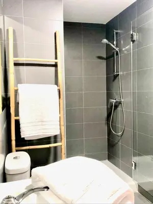 a bathroom with a shower and a toilet and a sink at The Cliffs - Sunset Village Beach 3E in Viveiro
