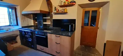 a kitchen with a stove and a counter top at Mirador del Navia in Serandinas