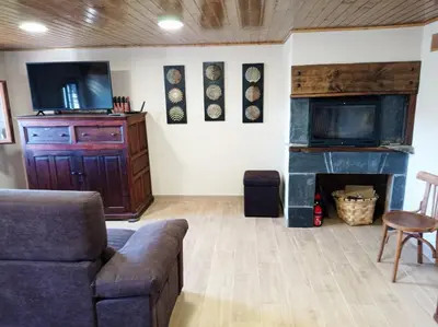 a living room with a couch and a fireplace at Mirador del Navia in Serandinas