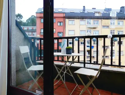 a balcony with a table and chairs on a balcony at Rías Altas Home Sada in Sada