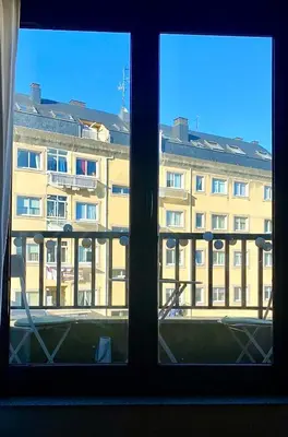a view of a large building from a window at Rías Altas Home Sada in Sada