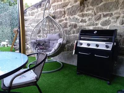 a grill and a swing with a table and a table at Rincón del Viso in Ourense
