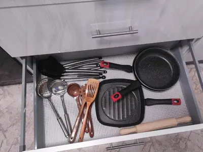 a drawer filled with cooking utensils in a cabinet at Casa Costal in Mondariz