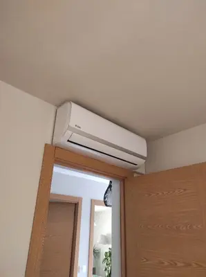 a white air conditioner on a ceiling above a door at Casa Costal in Mondariz
