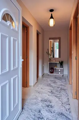 an open door in a hallway with a rug at Casa Costal in Mondariz