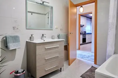 a bathroom with a sink and a mirror at Casa Costal in Mondariz