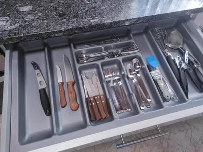 a tray filled with utensils in a drawer at Casa Costal in Mondariz