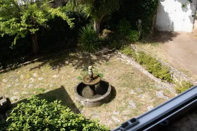 a small fountain in the middle of a yard at Pazo del siglo XVII en el corazón de Galicia in Lalín