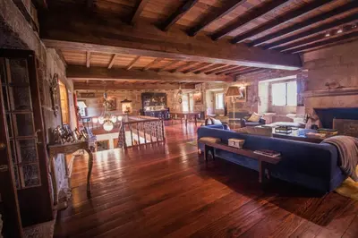 a living room with a blue couch and a table at Pazo del siglo XVII en el corazón de Galicia in Lalín