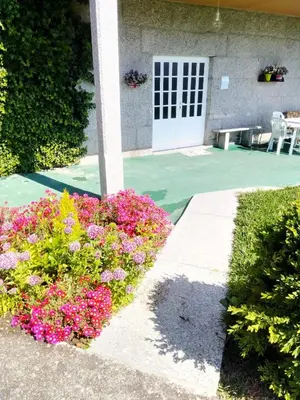 a garden with flowers in front of a house at La Favorita in Pontevedra