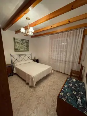 a bedroom with a bed and a large window at La Favorita in Pontevedra