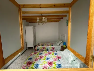a bedroom with a bed with a floral comforter at La Favorita in Pontevedra