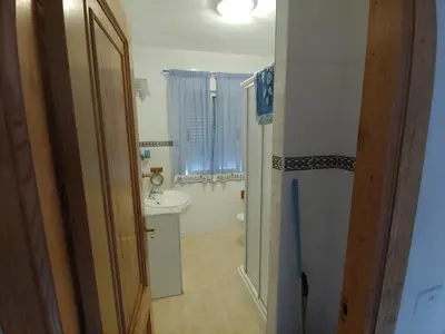 a bathroom with a sink and a toilet and a mirror at Casa Aroa in Barreiros