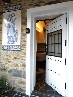 a door to a house with a painting on the wall at Apartamentos Minas de Silvarosa in Viveiro