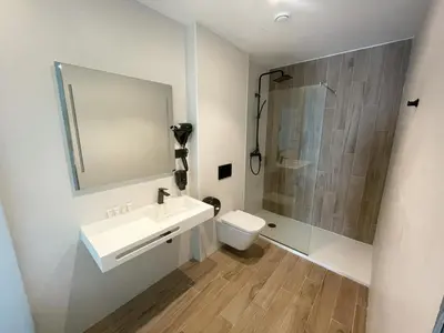 a bathroom with a sink and a shower and a toilet at Area 507 in Outeiro de Rei